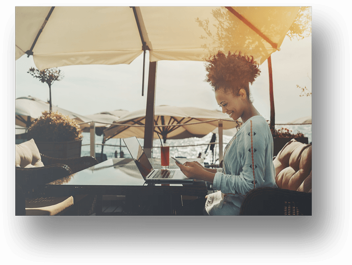 African-Woman-Sitting-At-Table-Smiling